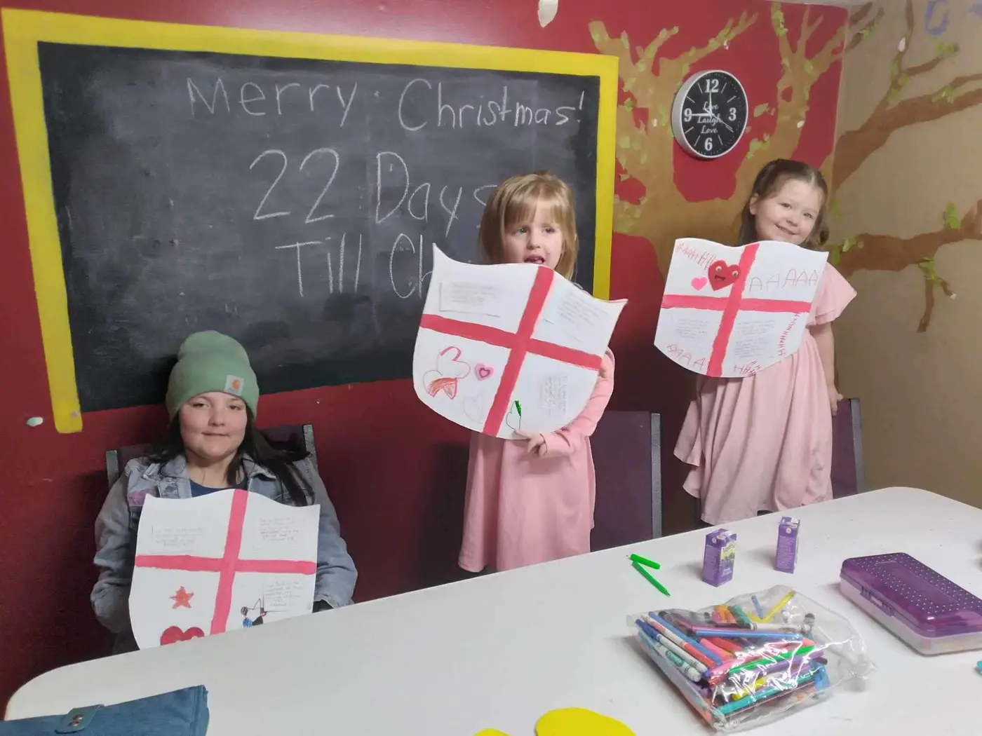 Children showing off their Sunday School crafts